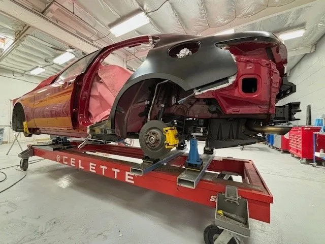 Alfa Romeo on a Celette frame bench for OEM quarter panel repair