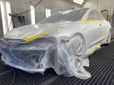 Tesla in the down-draft paint booth at Torrey Pines Collision Center